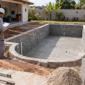 obra de construção de piscina com profissional medindo a estrutura em Goiânia